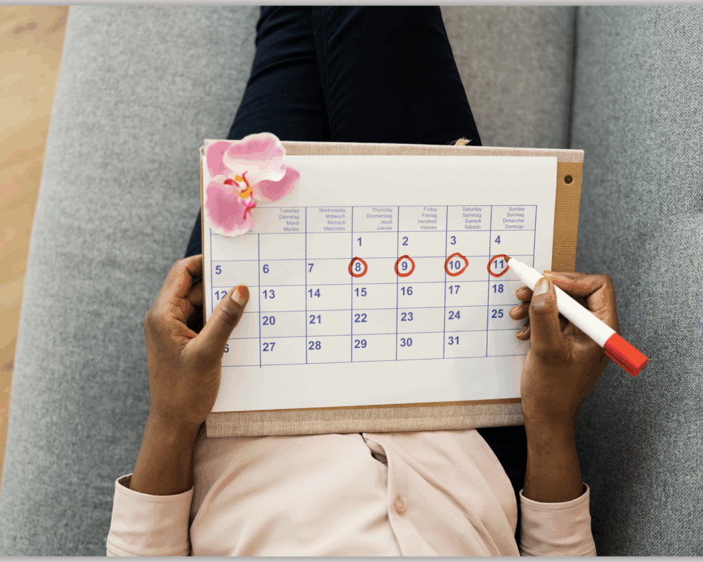 Person holding a calendar and checking off days to track consistency and habit building