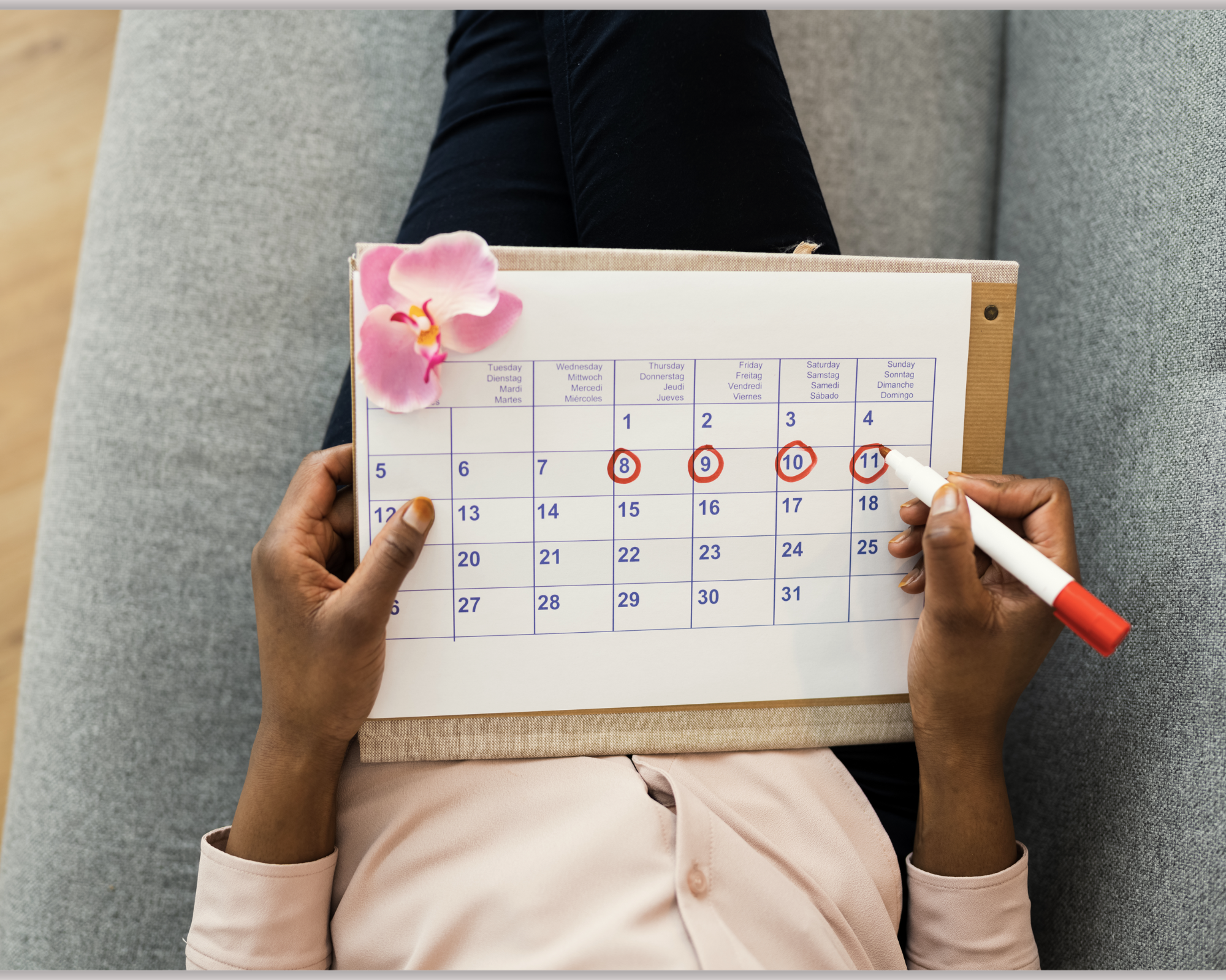 Person holding a calendar and checking off days to track consistency and habit building